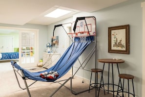 A room with a hammock, a basketball hoop, a framed picture, and a small round table. - 71-Acre Private Nature Retreat & Curated Heirloom Home Near Turkey Run (Bloomingdale)