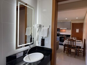 A bathroom with a sink, mirror, and hairdryer. - 101 | Res. 287 • Best Value, just 5 minutes on foot from the beach (Bombinhas)