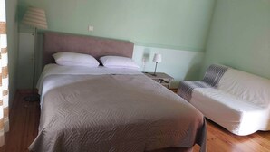 A bedroom with a bed, bedside table, lamp, and a sofa. - Geronymos Stone Villa Pool Chania Apokoronas Crete (Fres)