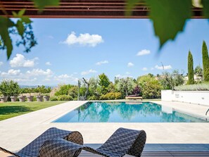 A swimming pool with lounge chairs, surrounded by greenery and a clear sky. - Mulberry Garden by Interhome (Belvedere Ostrense)