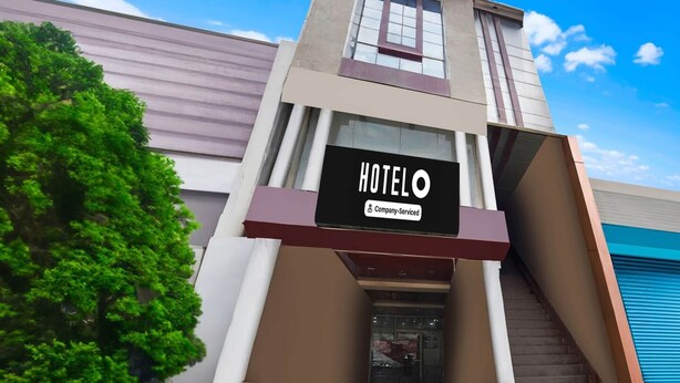 A hotel building with a sign reading 'HOTEL O' and 'Company-Serviced.' - Super Deluxe Room Prayagraj Shantila Inn (Prayagraj)