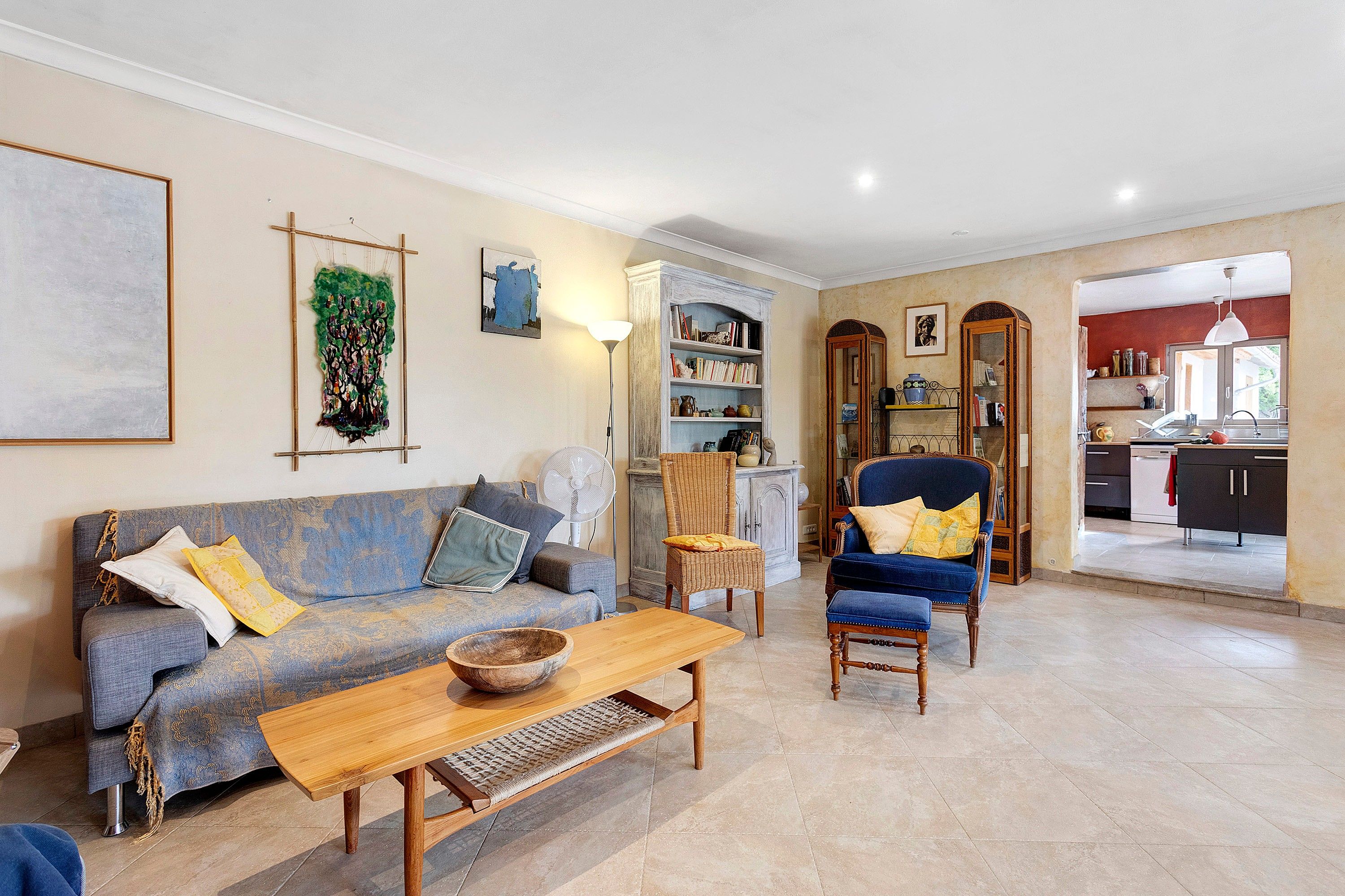 A living room with a sofa, armchair, and a wooden coffee table.