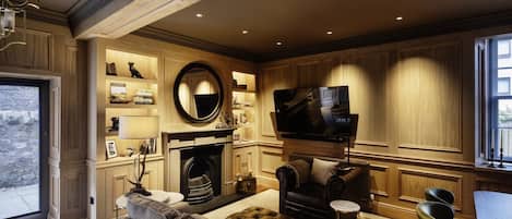 A living room with a fireplace, television, and comfortable seating.