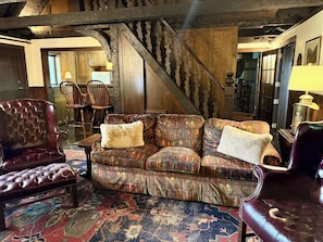 A cozy living room with a patterned sofa, leather armchairs, and a traditional rug. - Tynecastle Retreat - Views, Game Room & Patio (Banner Elk)