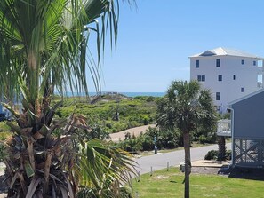 A coastal view with a white building, palm trees, and a clear sky. - Dog-Friendly End Unit· Gulf Views· 1 Min to Beach (Port St Joe)