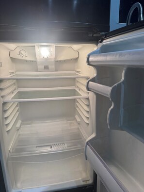 An empty refrigerator with multiple shelves and a water dispenser. - Adorable private room at side of house  in Norwalk perfect for your next getaway (Norwalk)