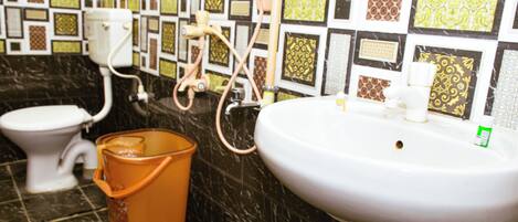 A bathroom with a toilet, sink, and shower.