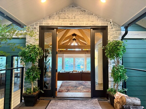 A modern interior with a stone archway leading to a cozy seating area.