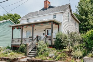 A two-story house with a porch, a staircase, and a brick chimney. - The Mariposa: Walk Downtown + Free Parking (Staunton)