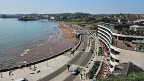 A coastal cityscape with a beach, promenade, and modern buildings. - Belgravia Holiday Apartments No 4 (Torquay)