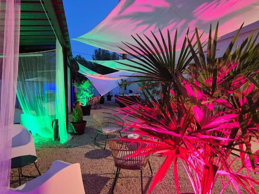 A patio area with outdoor seating, a covered area, and potted plants.