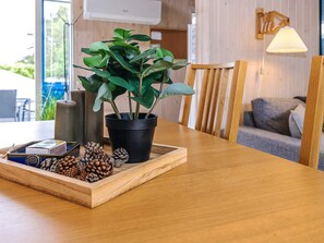 A wooden table with a potted plant, pinecones, and a decorative tray. - 4 Person Holiday Home in Saeby (Sæby)