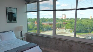 A bedroom with a large window, a bed, a lamp, and a framed picture on the wall. - Relax, Recharge, Explore. Where Luxury Meets Comfort l The Perfect Atlanta Stay (Atlanta)