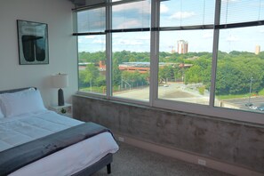 A bedroom with a large window, a bed, a lamp, and a framed picture on the wall. - Relax, Recharge, Explore. Where Luxury Meets Comfort l The Perfect Atlanta Stay (Atlanta)
