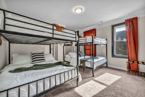 A bunk bed room with a window and curtains. - Near Tremont - 4BR - Sleeps 15 - Xbox (Cleveland)