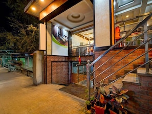 A hotel entrance with a staircase, a sign for 'D O ROOMS,' and a view of the interior. - Collection O Whitefield Bangalore (Bengaluru)