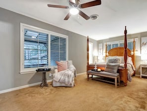A bedroom with a four-poster bed, a ceiling fan, a large window with blinds, and a small table with a tray. - Welcome to The Lawerence House! Full of room and special touches!! (Lufkin)