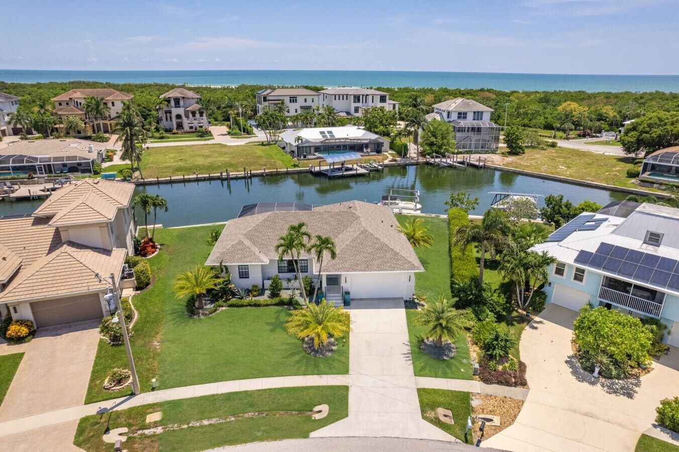 A residential area with houses, a swimming pool, and a marina.