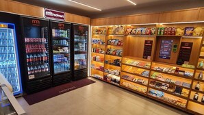 A Redmart store with refrigerated beverage dispensers, snack shelves, and a Redmart logo. - F.206 | Your Refuge with comfort and good taste (Tamandaré)