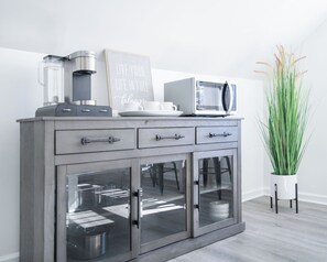 A modern kitchen with a built-in coffee maker, microwave, and a chalkboard sign. - 1 Block Off Main Downtown Greenville (Greenville)