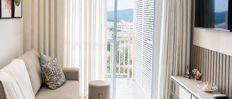 Premium Apartment, Pool Access, Beach View | Living area | 40-inch Smart TV with digital channels, Netflix, pay movies