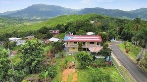 Un quartiere residenziale con case, una strada e montagne sullo sfondo.