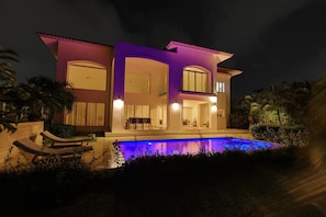 A modern two-story house with a swimming pool, large windows, and a balcony. - Spacious 4-bedroom house in serene Punta Cana with AC (Punta Cana)