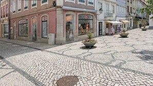 A historic building with a tiled facade, multiple windows, and a cobblestone plaza. - Aveiro History Apartments (Aveiro)