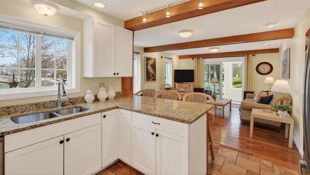 A kitchen with white cabinets, granite countertops, and a wooden ceiling. - Private Coastal 3 BD Residence in Ocean Park (Old Orchard Beach)