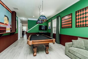 A pool table in a room with green walls, a sofa, and a mural. - 5BR Private Pool Home at Veranda Palms (Kissimmee)