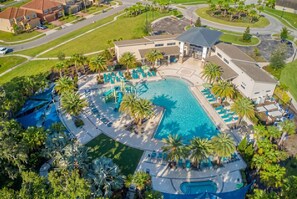 An aerial view of a resort with a central swimming pool, palm trees, and a parking area. - 5BR Private Pool Home at Veranda Palms (Kissimmee)