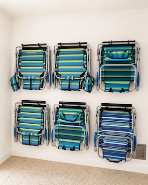 Six hospital beds with striped covers arranged in two rows on a white wall. - Heart of Pine Ave | 6 En-Suites | Heated Pool (Anna Maria)