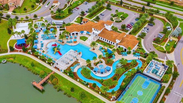 An aerial view of a resort with a swimming pool, tennis court, and landscaped areas. - Upstay Lake View Villa with Hot Tub, Pool & Resort (Kissimmee)