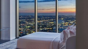 A high-rise hotel room with a large window offering a cityscape view. - Presidential Penthouse Private Infinity Pool (Miami)