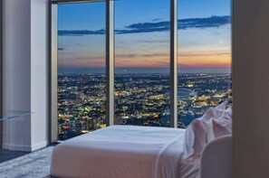 A high-rise hotel room with a large window offering a cityscape view. - Presidential Penthouse Private Infinity Pool (Miami)