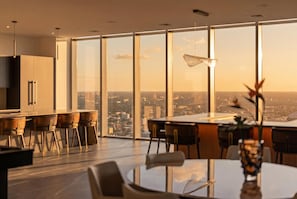 A modern dining area with a city view, large windows, and contemporary furniture. - Luxury Penthouse E11even Top Floor w Private Pool (Miami)