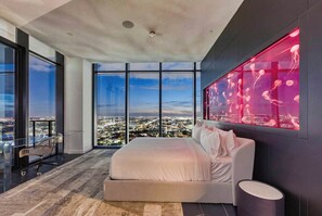 A modern bedroom with a large bed, a glass desk, and a city view. - Luxury Penthouse E11even Top Floor w Private Pool (Miami)