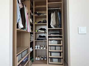 A wooden closet with shelves for folded clothes, hanging space, and shoe storage. - Villa Lamartine, 10 minutes from the beach and downtown—BRAND-NEW … (Provence-Alpes-Côte d'Azur)