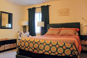 A bedroom with a bed, two bedside lamps, a mirror, a dresser, and a wall with a 'GOOD VIBES' sign. - New Listing! 1 Bed 1 Bath ny UC/OTR! (Cincinnati)