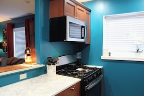 A compact kitchen with a stove, microwave, and cabinets. - New Listing! 1 Bed 1 Bath ny UC/OTR! (Cincinnati)