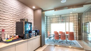 A modern office space with a coffee station, a conference room with glass walls, and a textured wall. - Near Trails & Eats | Weekly & Monthly Specials (Richardson)