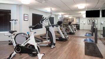 A gym with stationary bikes, treadmills, and exercise equipment.