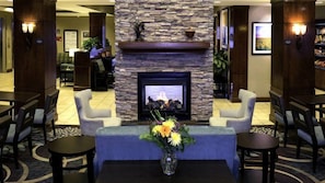 A lobby with a stone fireplace, seating area, and a reception desk. - King Suite Near Denver Airport | Free Breakfast (Denver)