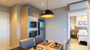 A modern hotel room with a dining area, kitchenette, and a separate bedroom. - House in Condo. w/ Garage in Salvador Tstedf0401 (Salvador)
