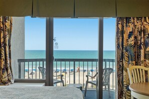 Habitación de hotel con balcón con vistas a la playa.