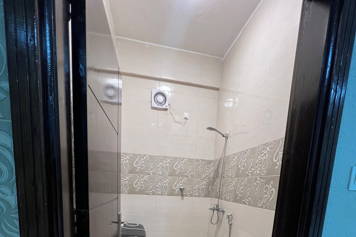 A bathroom with a toilet, bidet, and shower.