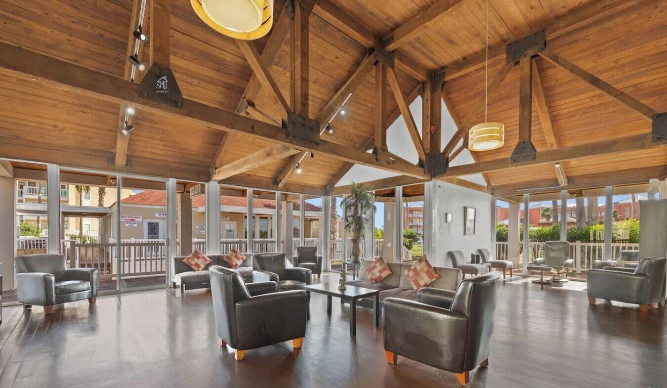 A spacious lobby with high ceilings, leather sofas, and a view of the outside.