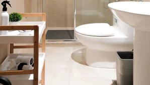 A modern bathroom with a shower, toilet, and sink. - New! 2BR w/ City Views in Makati & Fast Wi-Fi! (Makati)