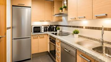 Une cuisine moderne dotée d’appareils électroménagers en acier inoxydable, de meubles en bois et d’un plan de travail en granit.