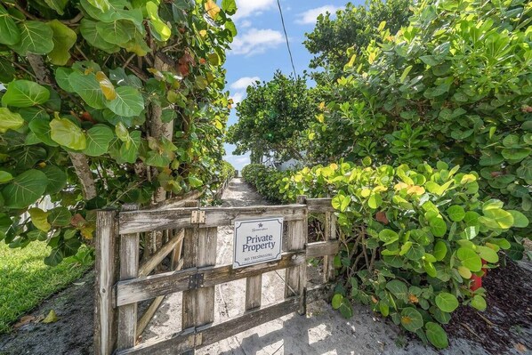 A wooden gate with a sign reading 'Private Property No Trespassing.' - Luxurious Retreat At The Whispering Palms (Wabasso Beach)